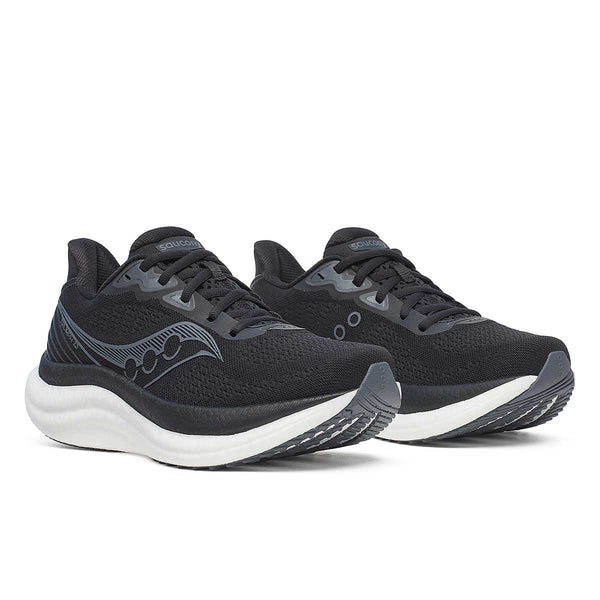 Pair of black Saucony running shoes with white soles on a white background