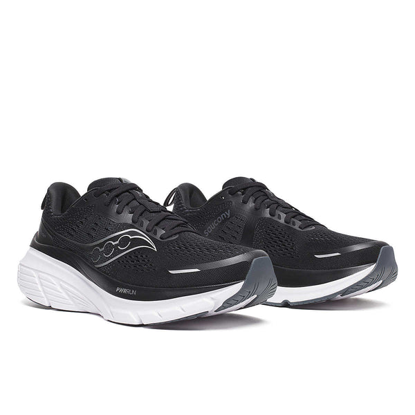 Pair of black running shoes with white soles on a white background. These are mens Saucony Guide 18 running shoes.