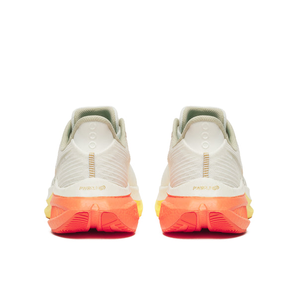 Pair of white sneakers with orange soles on a white background