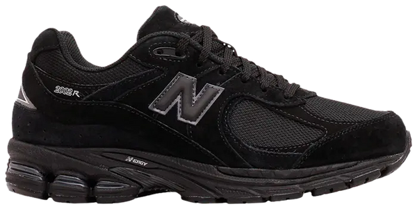 An all black 2002R new balance running shoes that is all black.