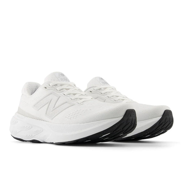 White running shoes with black soles on a white background