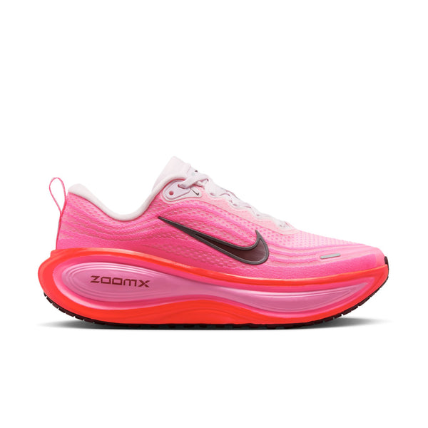 Pink running shoe with orange sole on a white background.