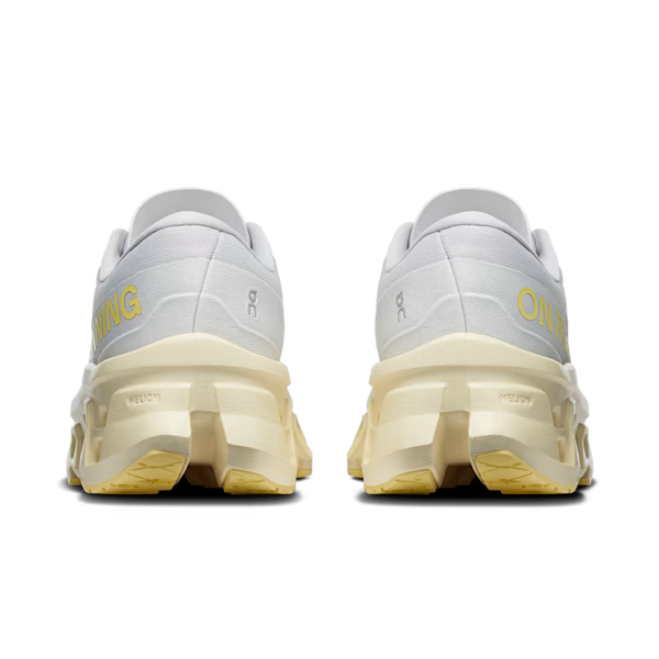 A pair of white and light beige running shoes shown from the back, featuring yellow 'RUNNING' text and the On logo, on a solid white background.