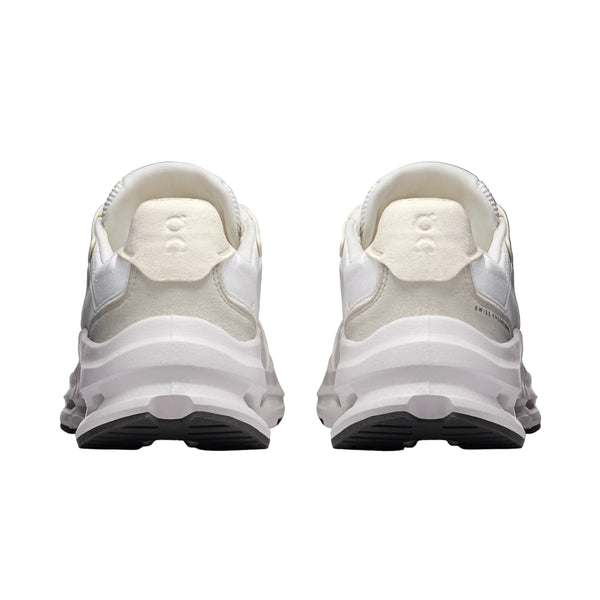 White athletic shoes with a black sole on a white background