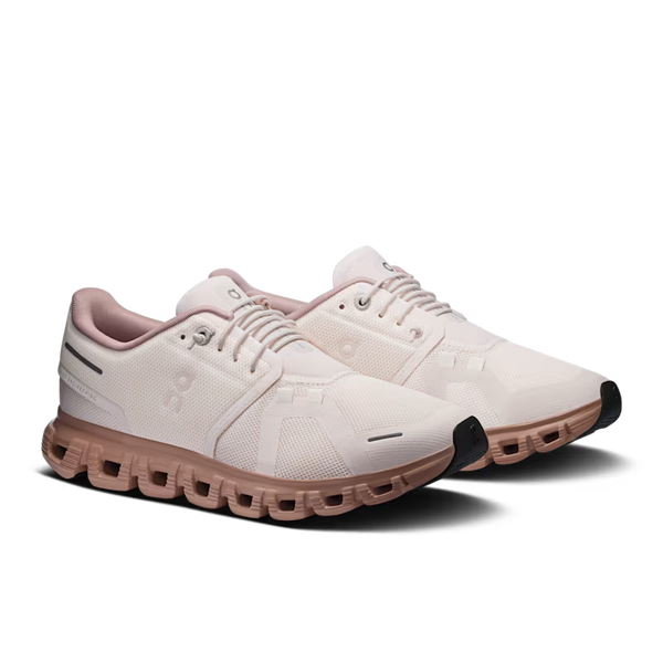 A pair of minimalist platform sneakers in off-white and dusty rose pink, featuring a chunky sculpted platform sole and black toe caps, shown on a clean white background.