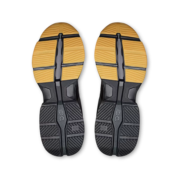 A black On running shoe with a textured mesh upper, black laces, a black midsole, and a contrasting brown outsole, on a white background.