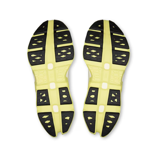 Close-up of a pair of yellow and black athletic shoe soles on a transparent background