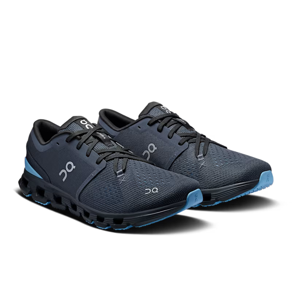 Pair of black running shoes with blue accents on a white background