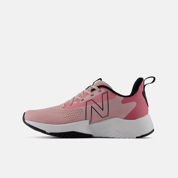 A pink New Balance athletic sneaker shown from the side profile against a solid white background. The shoe features a light pink mesh upper, a darker pink side panel with a large outlined 'N' logo, a white midsole, and black accents on the outsole and heel.