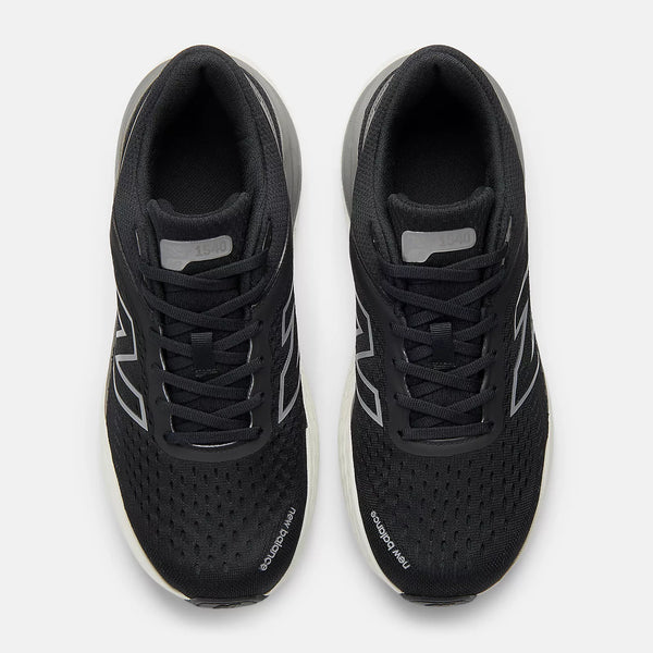 Black running shoes with white sole on a light gray background