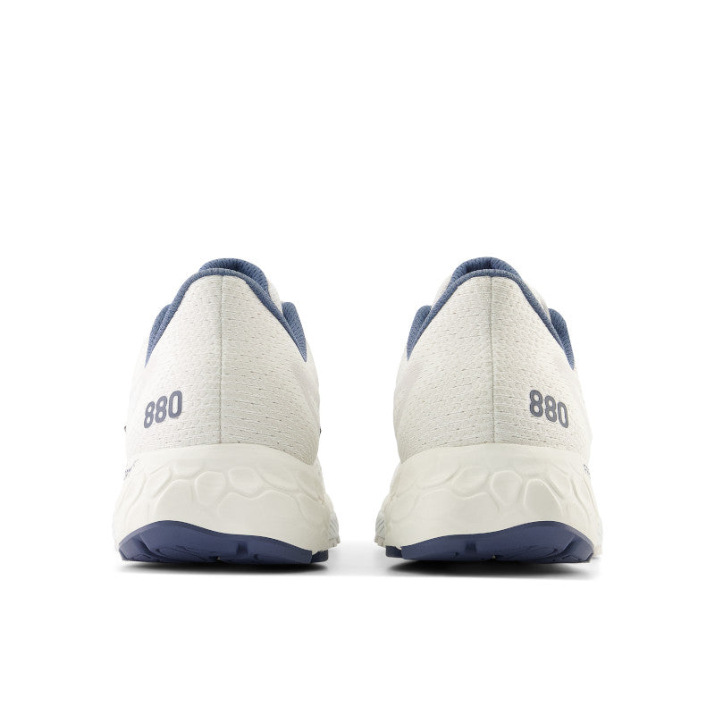 From behind the men's 880 the all white of the upper pops with the teal 880 color