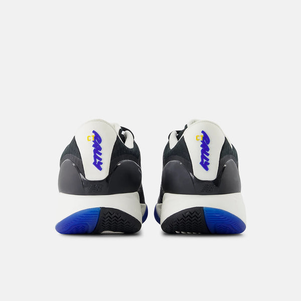A pair of Nike sneakers shown from the back, featuring a white and black leather upper with a white heel tab displaying the blue Nike 'Swoosh' logo, and a blue outsole.
