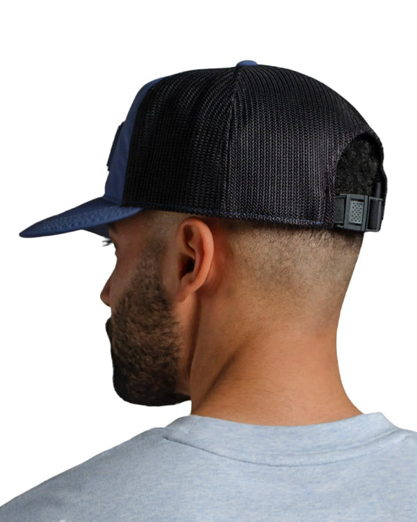 Person wearing a black and blue cap on a white background