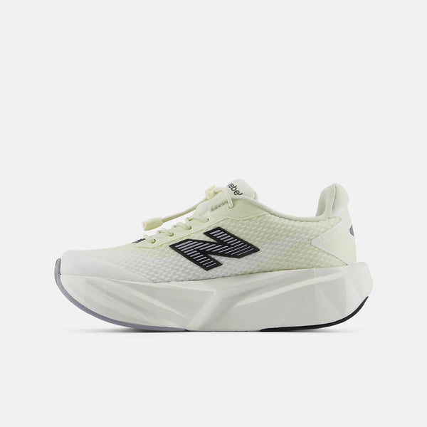 A New Balance sneaker in a pale yellow-green and white colorway, featuring a black 'N' logo on the side, set against a light gray background.