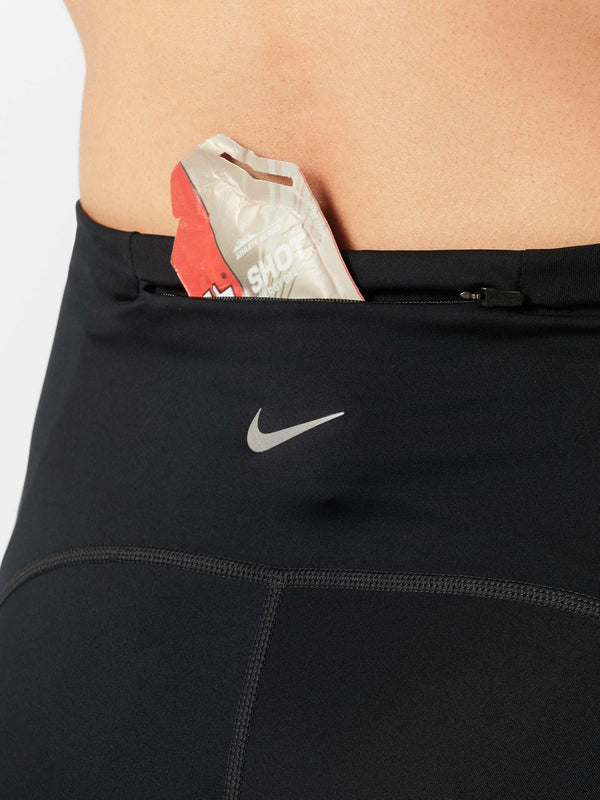 Black athletic pants with a Nike logo featuring a product inside the pocket.