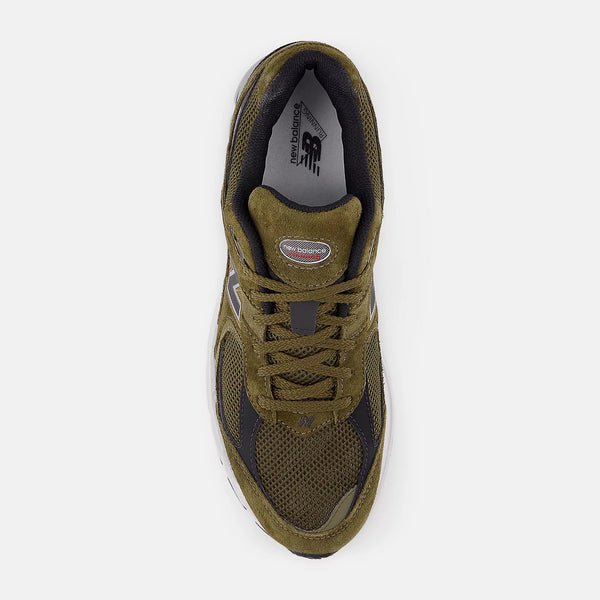 Green running shoe with New Balance logo on a white background