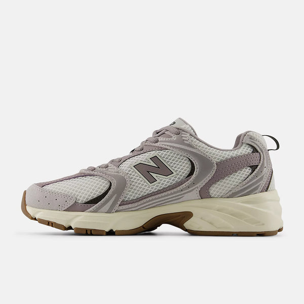 Gray sneaker with New Balance logo on a white background