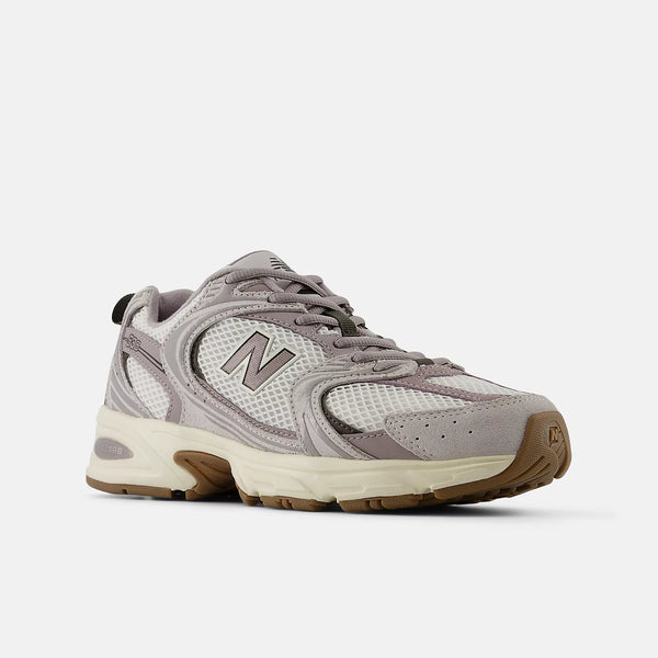 Gray sneaker with brown sole on a white background