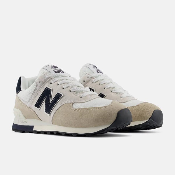 Beige and navy New Balance sneaker on a white background