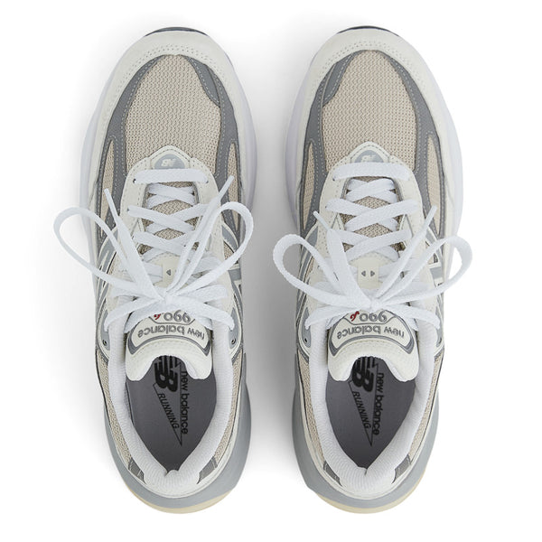 A pair of grey and white 990 v6 shoes that are great for fashion and walking.