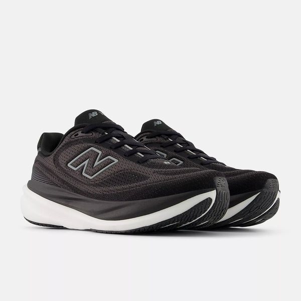 Black New Balance sneakers with white soles on a white background