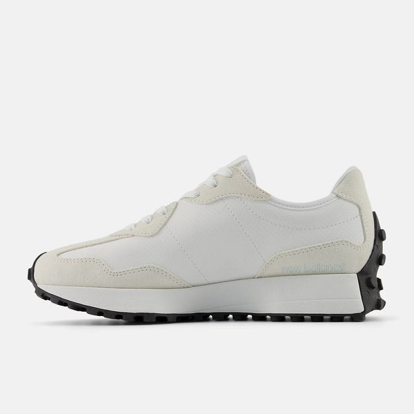 White sneaker with black sole on a white background