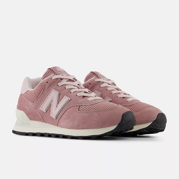 A pair of New Balance 574 lifestyle shoes with a speckled black outsole.