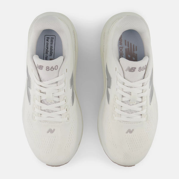 Pair of white sneakers with New Balance branding on a light gray background