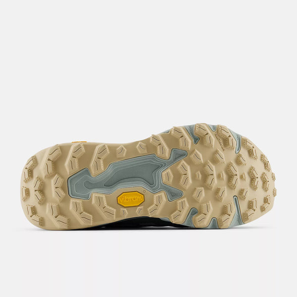 Close-up of a beige and gray shoe sole with a yellow accent on a white background