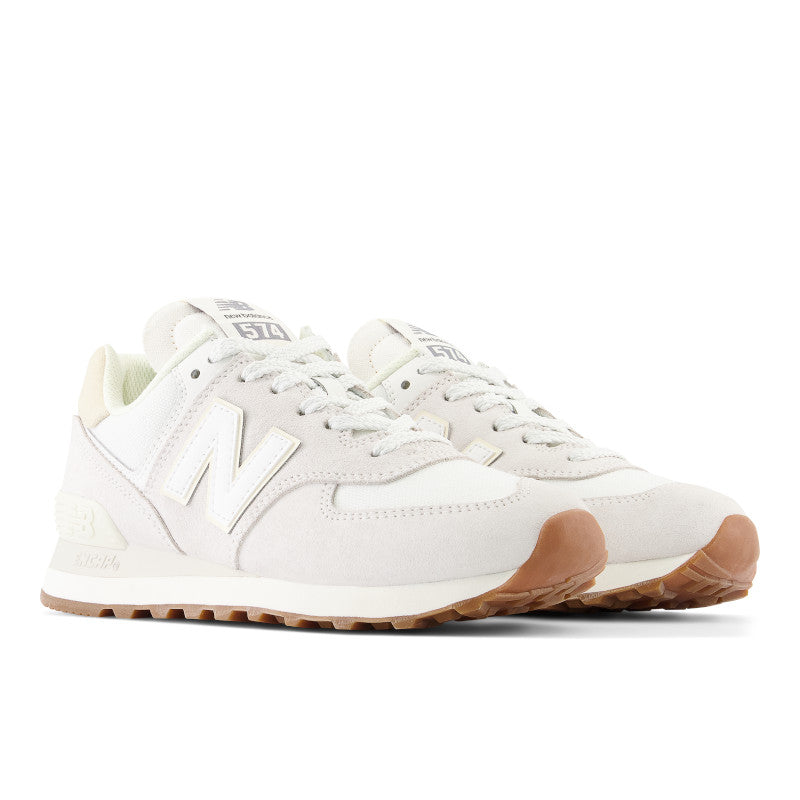 From the diagonal view of the pair of women's 574's, the gum sole rubber is visible