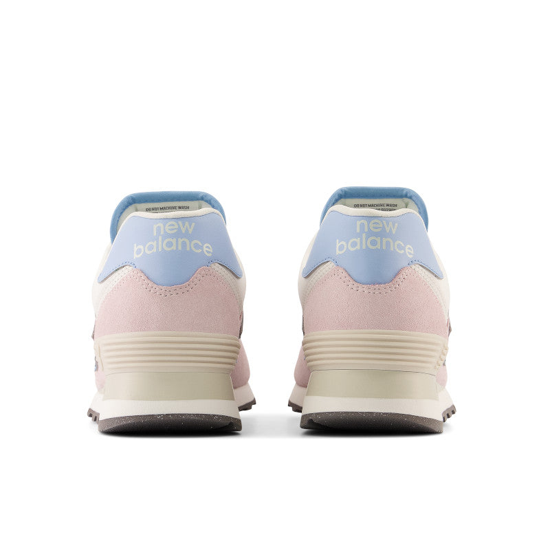 The heel of this womens 574 has new balance written in white on top of a very light blue