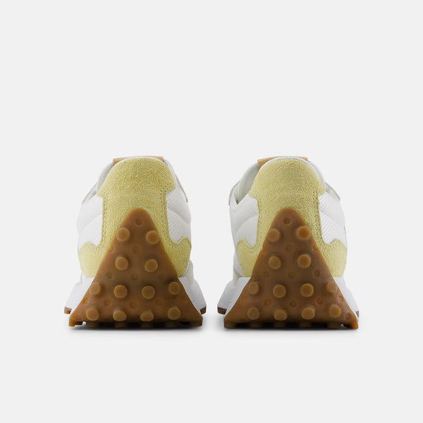 White and beige sneaker with New Balance logo on a white background