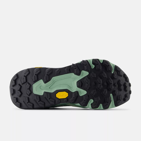 Close-up of a shoe sole with green and black pattern on a white background