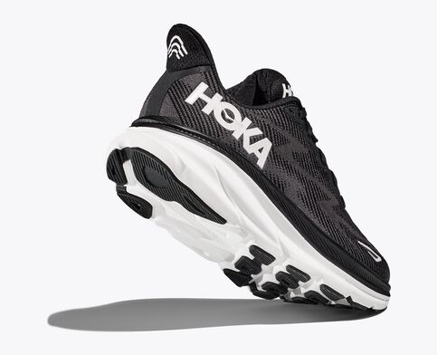 Back angled view of the Men's HOKA Clifton 9 in the men's wide 2E width, color Black/White