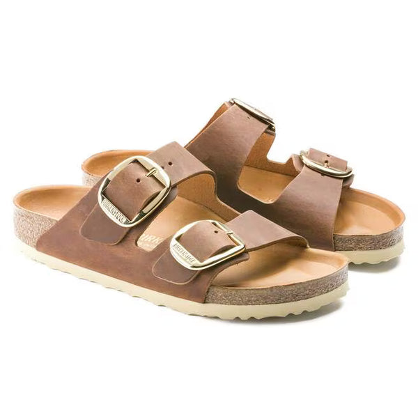 The oiled leather upper of this Arizona is medium brown and has large gold buckles.  