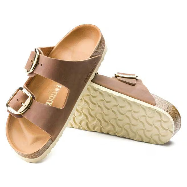The outsole of this shoe is cream and has a geometric pattern. Birkenstock is stamped into the leather upper on the medial side. 