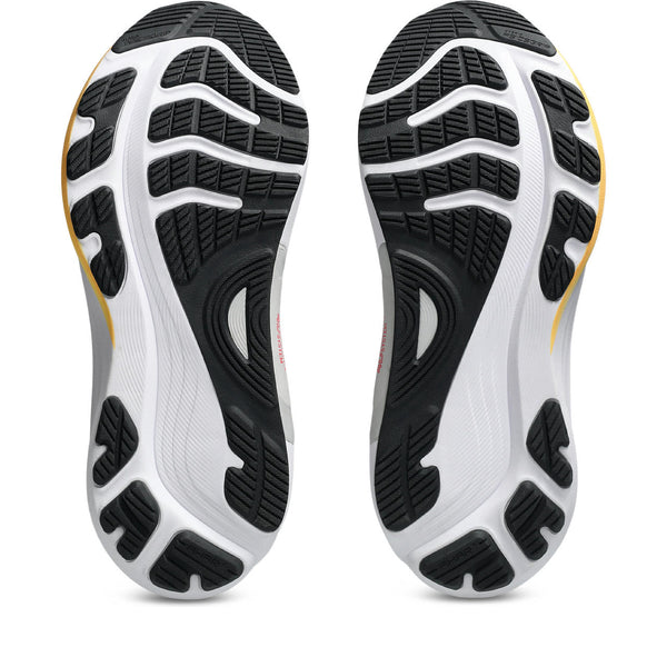 Close-up of a pair of ASICS running shoes with black and white sole design on a white background