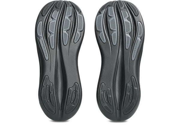 Black shoe soles with tread pattern on a white background