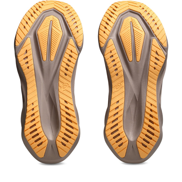 Close-up of a pair of brown and orange shoe soles on a white background.