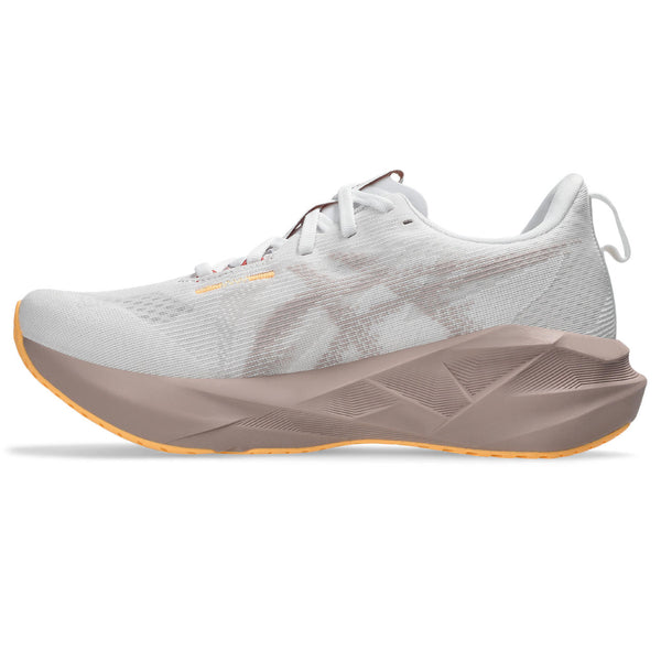 Medial side of a white running shoe with a beige sole on a white background.