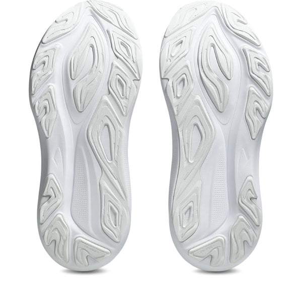 Close-up of white athletic shoes with tread pattern on a white background