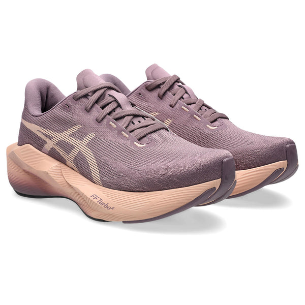 Purple running shoe with a beige sole on a white background