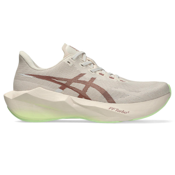 Beige running shoes with green accents on a white background