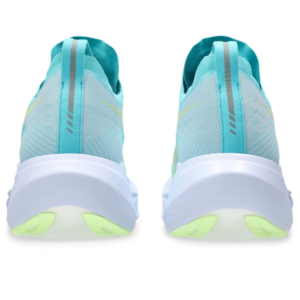 Light blue running shoes with white and green sole on a white background