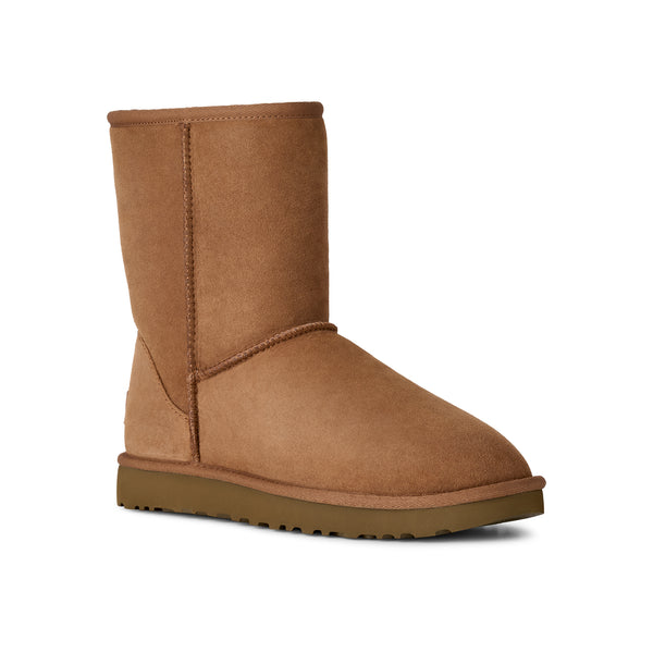 Calf height tan slipper boot on a white background