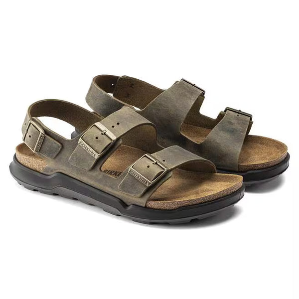 The oiled leather upper of this Milano is khaki and has brass buckles.  