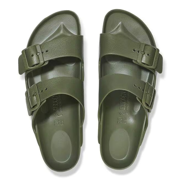 The buckles on the straps of this sandal are green and the sole of the shoe has Birkenstock printed vertically. 