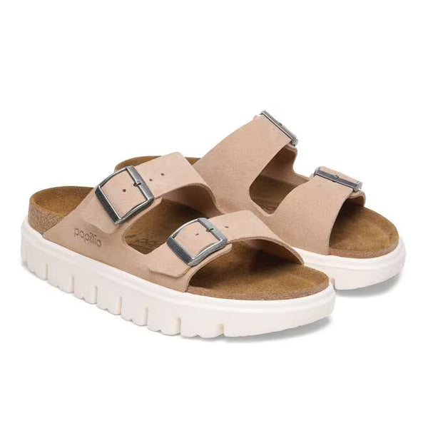 The suede upper on this sandal is a beige almost pink color and has silver buckles. 