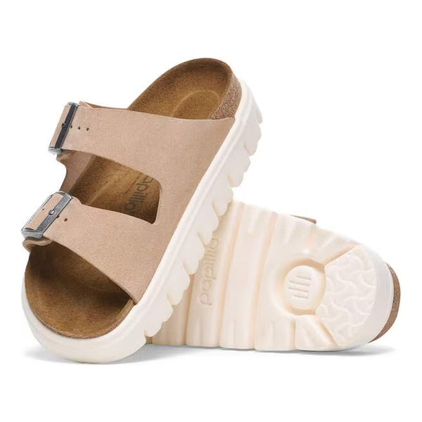 The EVA outsole on this shoe is white and has deep horizontal lines running through it. 