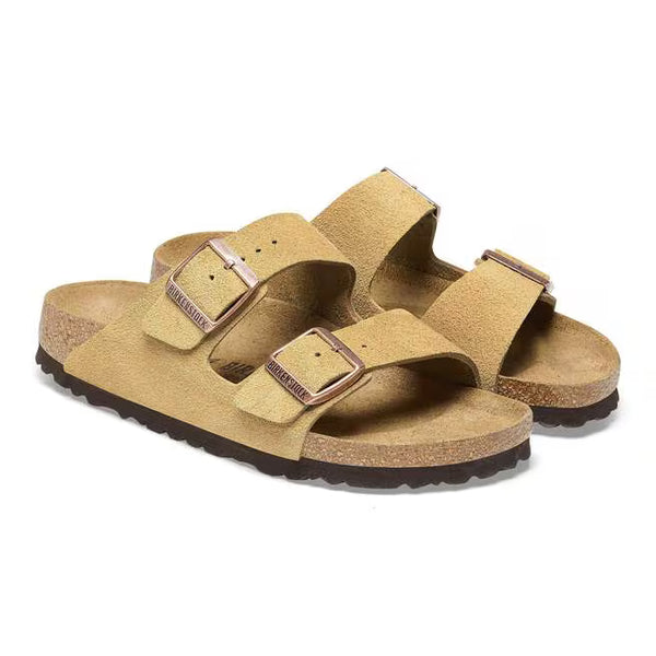 The suede upper of this Arizona is a beige color with brass buckles. 